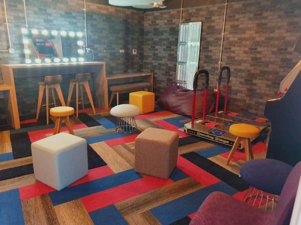 Coopervision breakout area with colourful lounge chairs, beanbags, and coffee tables installed by OfficeZone